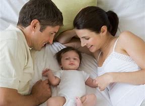 Photo of parents with a baby between them