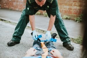 Point of view photo of an EMT assessing man on a gurney