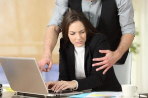 Image of woman being harassed at work